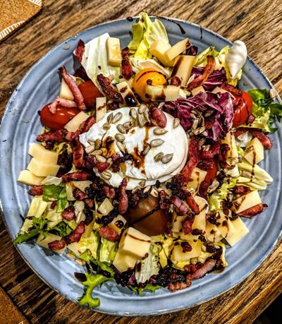 Salade gourmande au beaufort, lardons et œuf poché